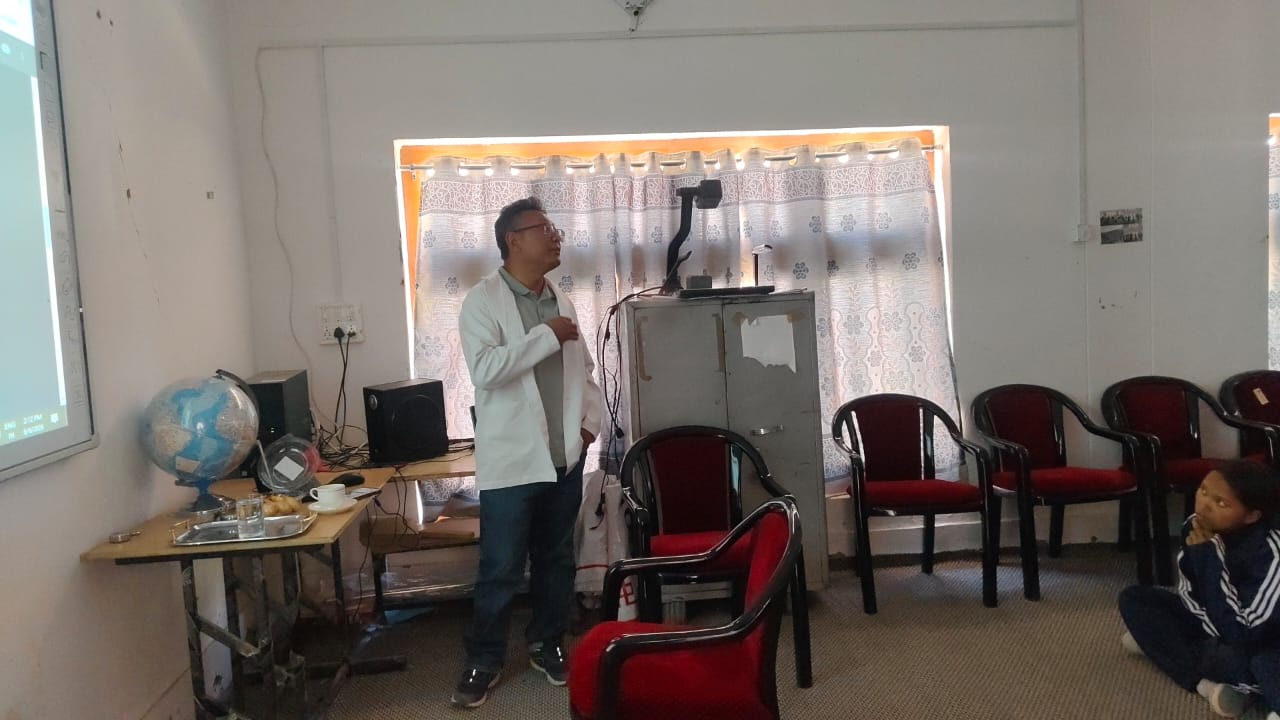 Smart Classroom Session Teacher delivering a lesson in front of a smart board projector inside a GHSS Sakti classroom